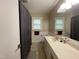 Neutral bathroom featuring a wide mirror, gray shower curtain, and spacious vanity at 321 Willowood Dr, Henderson, NC 27536