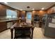 Kitchen with stainless steel appliances, wooden cabinets, tiled floors, and island with stools at 321 Willowood Dr, Henderson, NC 27536