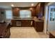 Kitchen with wooden cabinets, tiled floors and backsplash, and stainless steel dishwasher at 321 Willowood Dr, Henderson, NC 27536