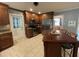 Kitchen with stainless steel appliances, wooden cabinets, tiled floors and eat-in table at 321 Willowood Dr, Henderson, NC 27536