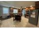 Traditional eat-in kitchen with a tiled floor, wooden cabinets, stainless steel appliances and center island at 321 Willowood Dr, Henderson, NC 27536