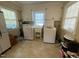 Well lit laundry room with white cabinets and modern washer and dryer at 321 Willowood Dr, Henderson, NC 27536