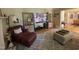 Comfortable living room with an ottoman, bookshelves, and an entrance to another room at 321 Willowood Dr, Henderson, NC 27536
