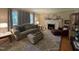 Well-lit living room with neutral tones, a fireplace, and comfortable seating arrangements at 321 Willowood Dr, Henderson, NC 27536