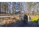 Outdoor deck with a grill, table, and chairs surrounded by privacy fencing and mature trees at 35 Wickersham Way, Louisburg, NC 27549