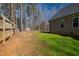 Fenced backyard with grass and trees, offering privacy and space for outdoor activities at 35 Wickersham Way, Louisburg, NC 27549