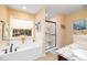 Serene bathroom featuring a soaking tub, a glass-enclosed shower, and a vanity with granite countertops at 35 Wickersham Way, Louisburg, NC 27549