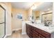 Well-lit bathroom features a double vanity with granite countertops and stylish fixtures, enhancing the space's appeal at 35 Wickersham Way, Louisburg, NC 27549