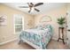 Inviting bedroom with a colorful bed, a ceiling fan, and a window that provides lots of natural light at 35 Wickersham Way, Louisburg, NC 27549