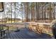 Wooden deck with white railings and a table with chairs, perfect for outdoor seating at 35 Wickersham Way, Louisburg, NC 27549