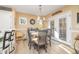 A dining area with a round table, gray chairs, and windows, perfect for enjoying meals and creating memories at 35 Wickersham Way, Louisburg, NC 27549
