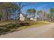 Charming single-story home with a ramp, attached garage, and well-maintained lawn, in a wooded setting at 35 Wickersham Way, Louisburg, NC 27549
