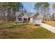 Charming single-story home with a ramp, attached garage, well-maintained lawn, and an American flag displayed at 35 Wickersham Way, Louisburg, NC 27549