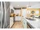 Modern kitchen featuring stainless steel appliances, granite countertops, a stylish faucet, and white cabinetry at 35 Wickersham Way, Louisburg, NC 27549