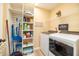 Well-organized laundry room with shelving, washer, dryer, and storage space, making laundry chores a breeze at 35 Wickersham Way, Louisburg, NC 27549