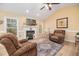 Bright living room features a fireplace, hardwood floors, and large windows creating a warm and inviting space at 35 Wickersham Way, Louisburg, NC 27549