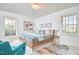 Bright bedroom features neutral walls, a modern bed, and cozy decor, creating a serene and inviting space at 3613 Hope Valley Rd, Durham, NC 27707