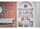 Close-up of built-in shelves and brick fireplace with decorative accents at 3613 Hope Valley Rd, Durham, NC 27707