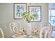 Cozy dining table is set with pretty dishes and flanked by chairs with decorative backs at 3613 Hope Valley Rd, Durham, NC 27707