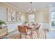 Stylish dining area featuring a wooden table set for four, complemented by artistic decor and modern lighting at 3613 Hope Valley Rd, Durham, NC 27707