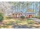 Red brick home with white shutters, covered parking and a front lawn with mature trees at 3613 Hope Valley Rd, Durham, NC 27707