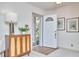 Inviting foyer featuring an open white door, cabinet, and neutral tones for a bright and welcoming entrance at 3613 Hope Valley Rd, Durham, NC 27707