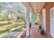 Covered front porch adorned with columns offers views of the manicured lawn, walkway and flowering tree at 3613 Hope Valley Rd, Durham, NC 27707