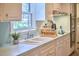 Well-lit kitchen area features sink, cabinets, and stainless steel appliances creating a functional space at 3613 Hope Valley Rd, Durham, NC 27707