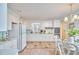 Bright kitchen featuring white cabinets, stainless steel appliances, and a breakfast nook dining area at 3613 Hope Valley Rd, Durham, NC 27707