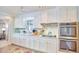 Classic white kitchen featuring stainless steel appliances, ample counter space, and natural light at 3613 Hope Valley Rd, Durham, NC 27707