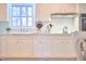 Sunlit kitchen sink area with classic fixtures, dish rack, and a view to the outdoors at 3613 Hope Valley Rd, Durham, NC 27707