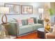 Inviting living room featuring a soft green sofa, decorative pillows, and modern accents for a cozy feel at 3613 Hope Valley Rd, Durham, NC 27707