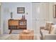 Chic living room with a stylish sideboard, wine glasses, and a comfortable sofa at 3613 Hope Valley Rd, Durham, NC 27707
