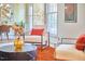 Bright living space with an armchair, warm accents, and natural light, creating an inviting atmosphere at 3613 Hope Valley Rd, Durham, NC 27707