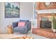 Bright living room featuring comfortable seating and a charming brick fireplace at 3613 Hope Valley Rd, Durham, NC 27707
