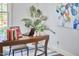 Close up view of a home office desk and potted plants at 3613 Hope Valley Rd, Durham, NC 27707