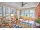 Bright sunroom features a wall of windows and comfortable rocking chairs for relaxing at 3613 Hope Valley Rd, Durham, NC 27707