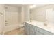 Bright bathroom with dual-sink vanity, modern fixtures, and a shower-tub combo, offering a clean, functional design at 396 Hopewell Branch Ct, Smithfield, NC 27577