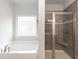Modern bathroom with separate soaking tub and glass enclosed shower at 396 Hopewell Branch Ct, Smithfield, NC 27577