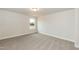 A simple bedroom features carpet and a single window offering natural light and a calm atmosphere at 396 Hopewell Branch Ct, Smithfield, NC 27577
