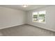 Bright bedroom features a carpet and a single window offering a pleasant view of the outdoors at 396 Hopewell Branch Ct, Smithfield, NC 27577