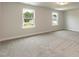 Bright bedroom with carpet, two windows showcasing scenic outdoor views and ample natural light at 396 Hopewell Branch Ct, Smithfield, NC 27577