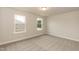 A bright, carpeted bedroom with two windows provides natural light and showcases the surrounding outdoor views at 396 Hopewell Branch Ct, Smithfield, NC 27577