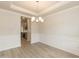 Formal dining room with elegant trim, a stylish chandelier, and wood-look flooring at 396 Hopewell Branch Ct, Smithfield, NC 27577