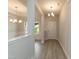 Bright foyer with wood-look floors, decorative lighting, and views into adjacent rooms at 396 Hopewell Branch Ct, Smithfield, NC 27577