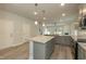 Kitchen features granite countertops, gray cabinets, stainless appliances, and a center island at 396 Hopewell Branch Ct, Smithfield, NC 27577