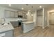 Modern kitchen with gray cabinets, granite countertops, an island, and stainless steel appliances at 396 Hopewell Branch Ct, Smithfield, NC 27577