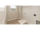A functional laundry room features washer/dryer connections, shelving, and a window, offering practicality and convenience at 396 Hopewell Branch Ct, Smithfield, NC 27577