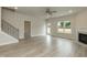 Spacious living room featuring a cozy fireplace, modern staircase, and ample natural light at 396 Hopewell Branch Ct, Smithfield, NC 27577