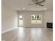 Bright living room featuring a fireplace, exterior door, and large windows with backyard views at 396 Hopewell Branch Ct, Smithfield, NC 27577
